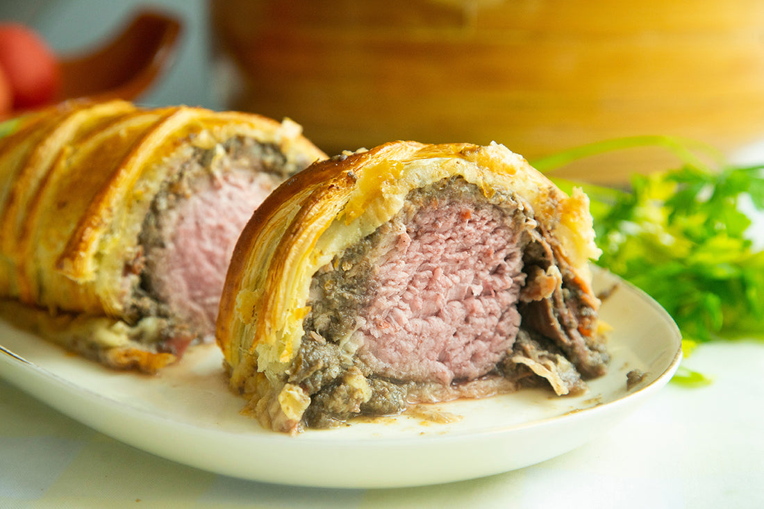 A Show-Stopping Pork Wellington with Hasselback Potatoes, Honey Parsnips, Coriander-Roasted Carrots, and Dijon Mustard Cream Sauce